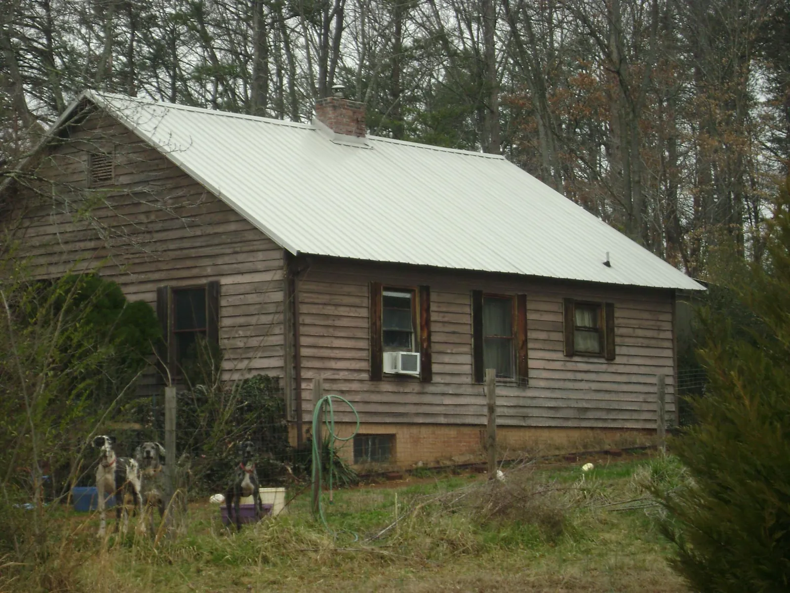 White metal roof on an old wood sided farmhouse, from a Metal Roof Installation job in Kenoza Lake